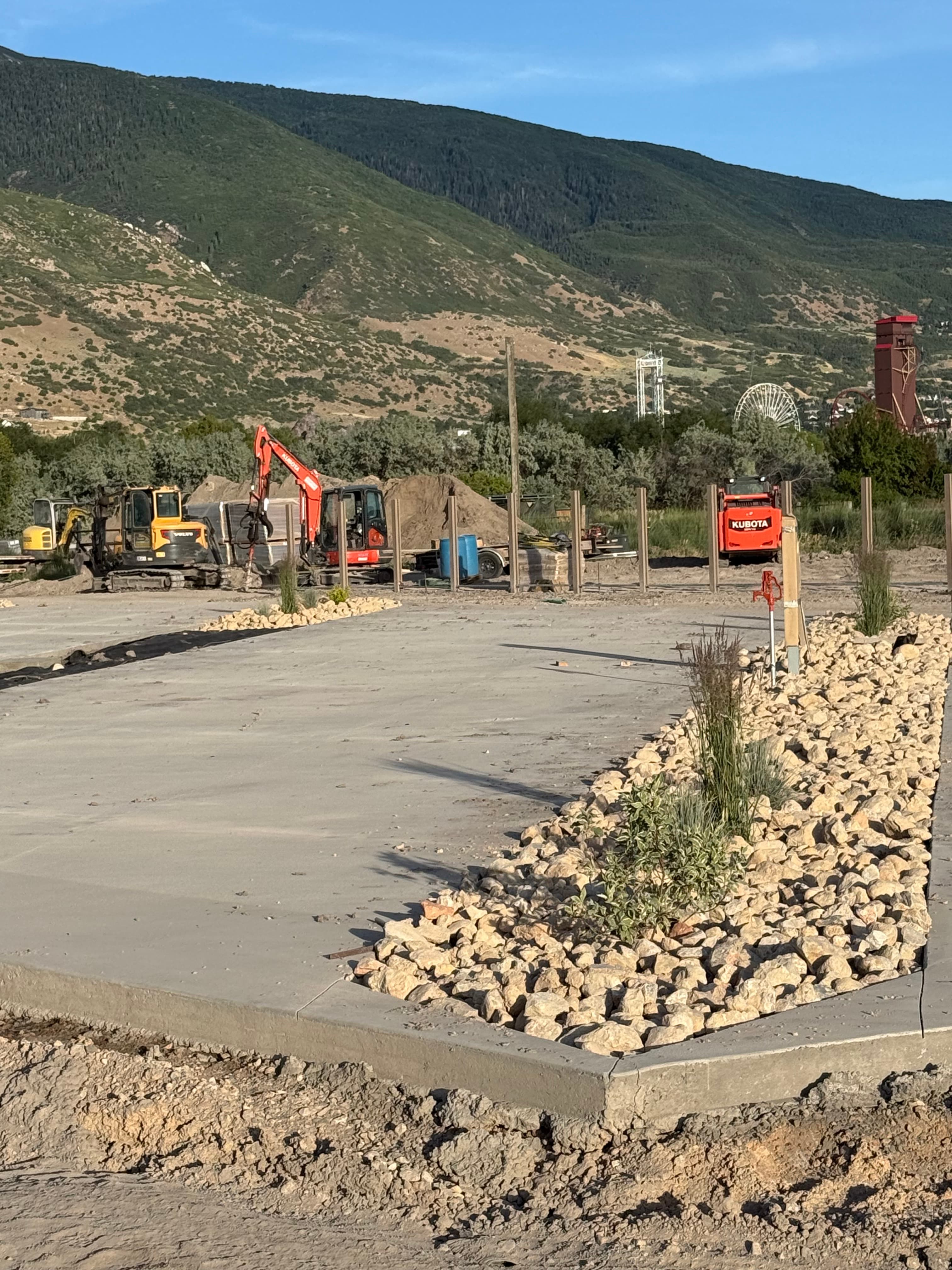 Spring Creek RV Resort completed concrete pad with rock landscaping and natural surroundings