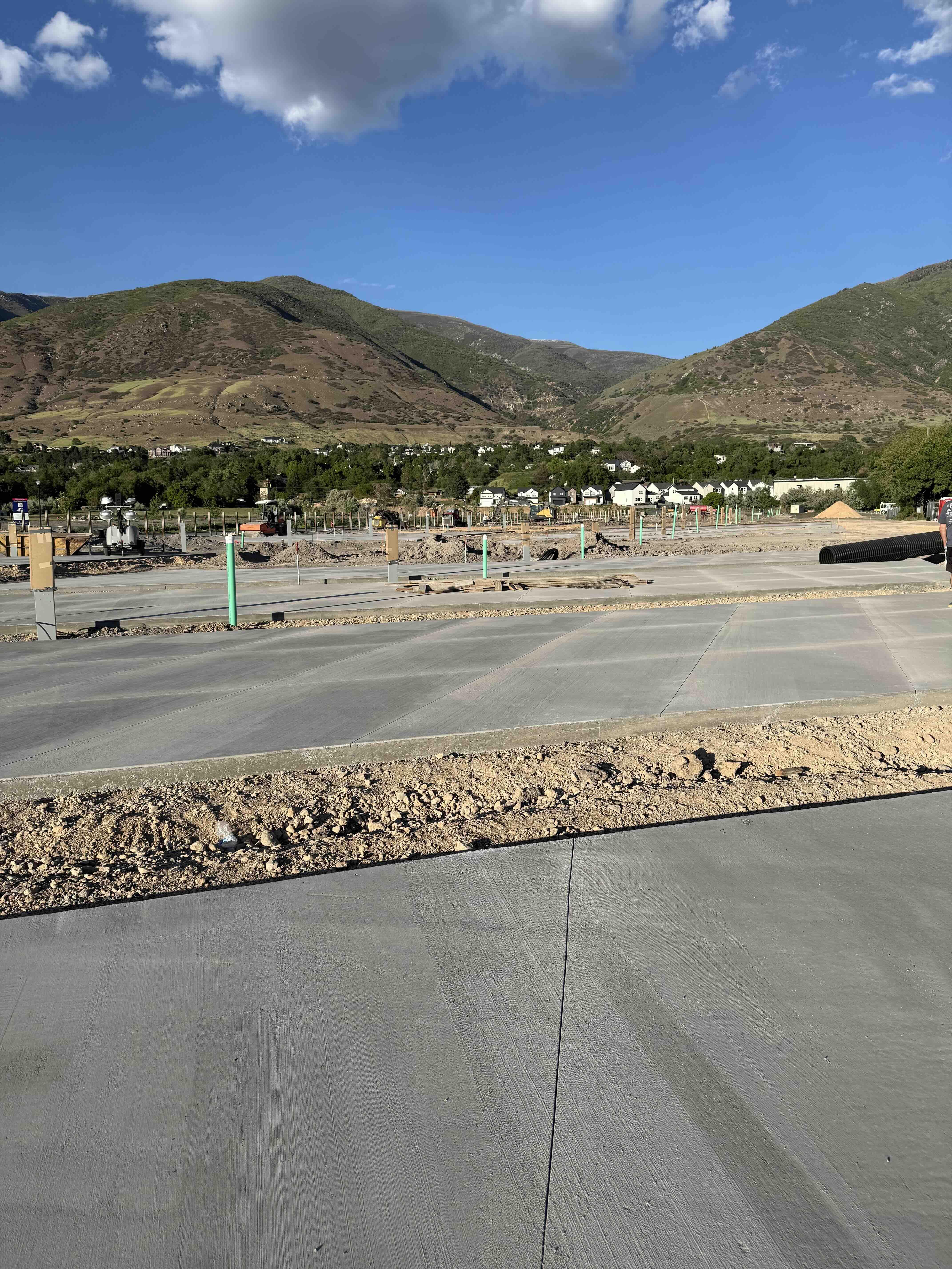 Spring Creek RV Resort construction — fresh concrete RV pads with Wasatch mountain views, Farmington Utah