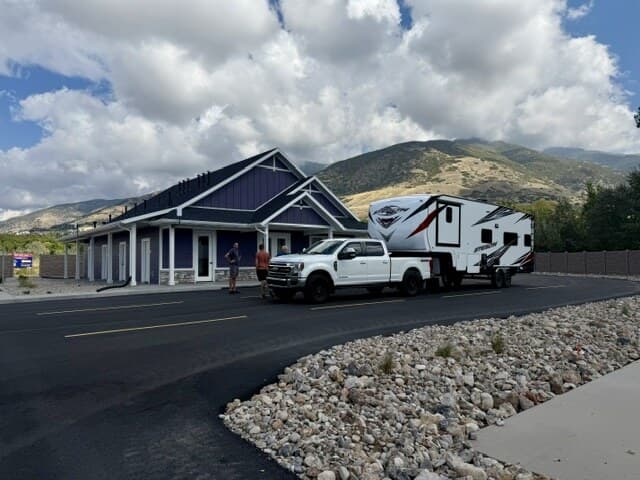 Guests arriving with a truck and fifth-wheel trailer at the Spring Creek RV Resort office