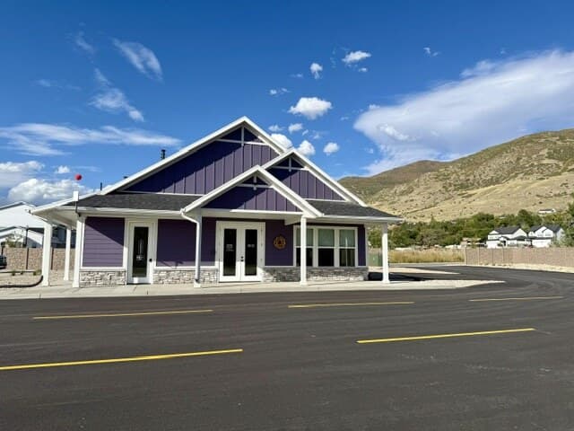 Spring Creek RV Resort office with purple siding and stone accents